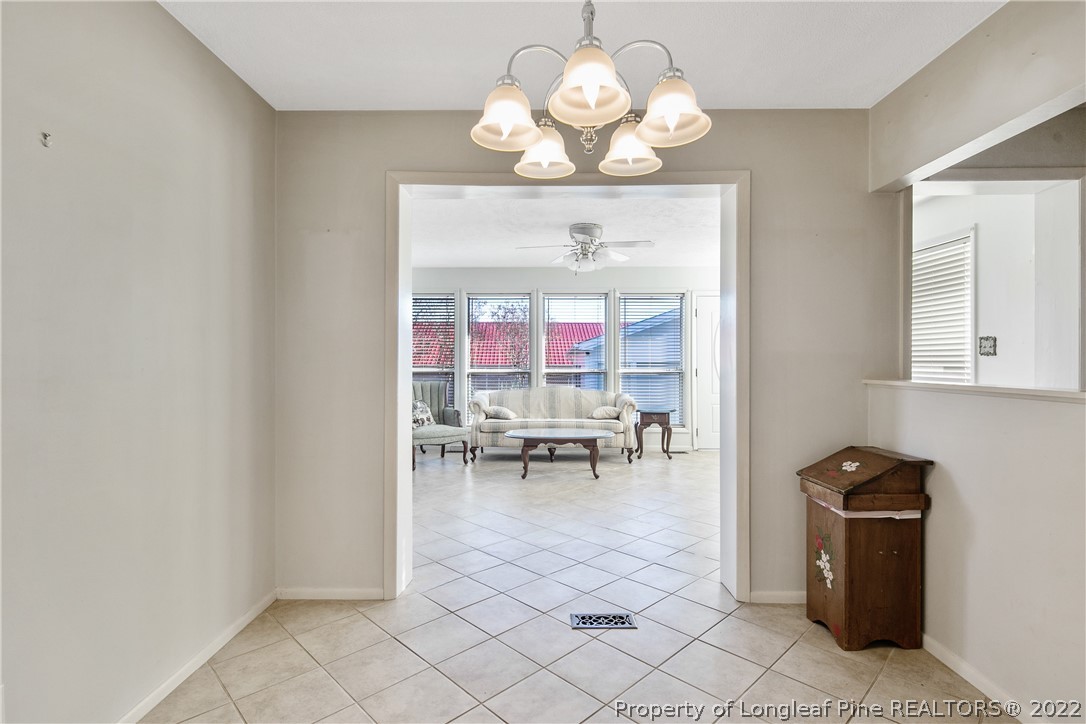 211 Duncan Road Spring Lake, NC 28390 - Photo 19 of 46 a living room with furniture a chandelier and a dining table
