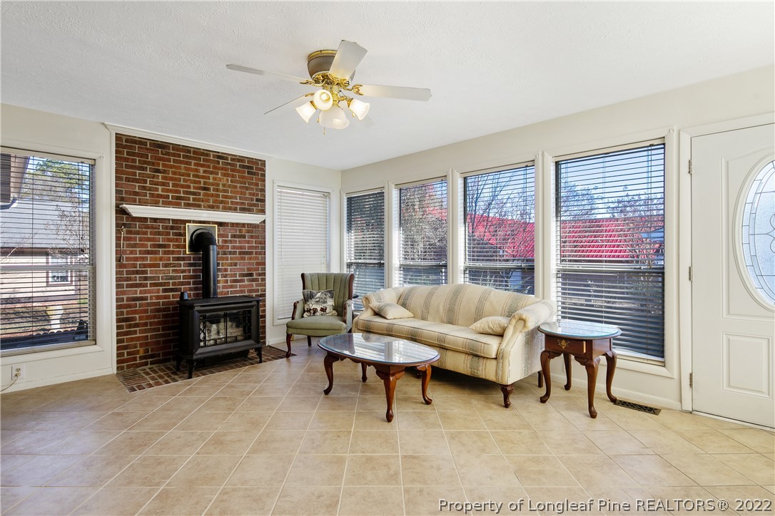 211 Duncan Road Spring Lake, NC 28390 - Photo 23 of 46 a living room with furniture a fireplace and a flat screen tv