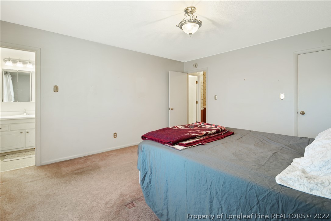 211 Duncan Road Spring Lake, NC 28390 - Photo 29 of 46 a bedroom with a bed and a cabinets