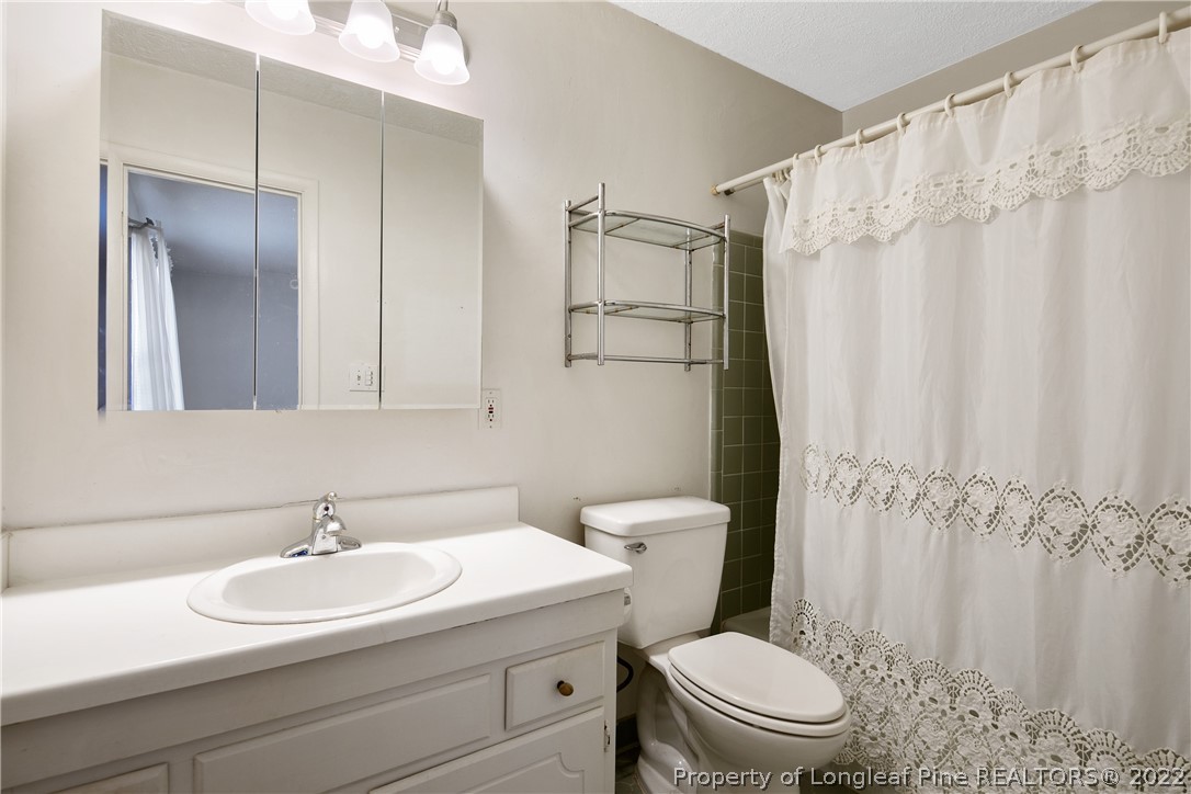 211 Duncan Road Spring Lake, NC 28390 - Photo 30 of 46 a bathroom with a sink a toilet and shower