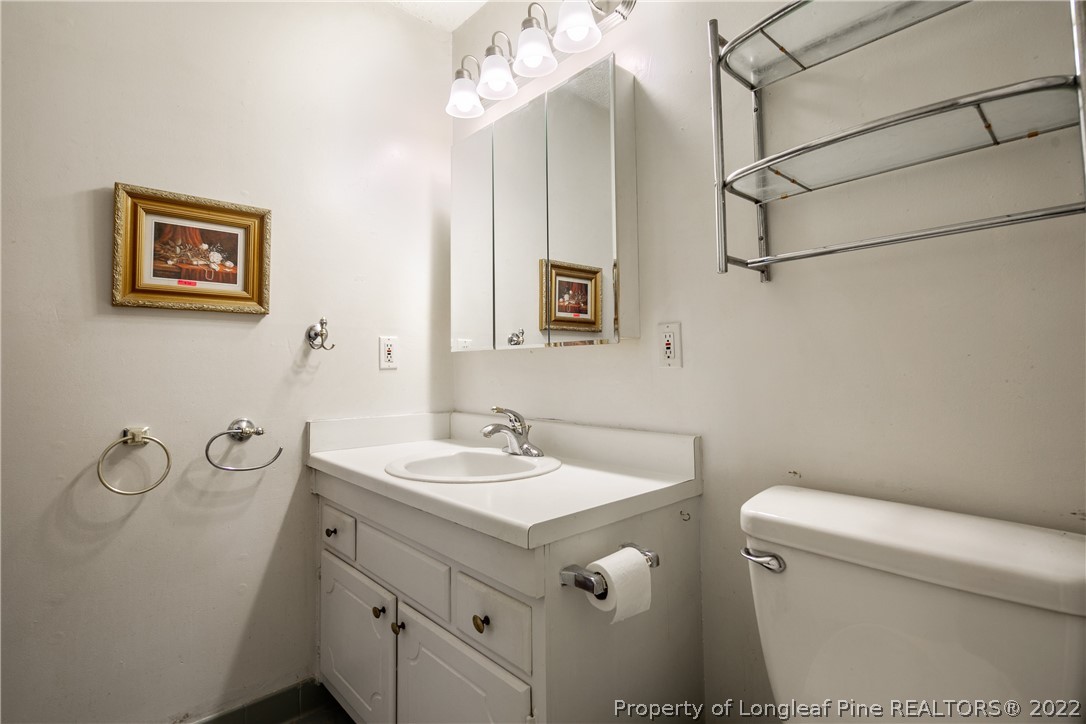 211 Duncan Road Spring Lake, NC 28390 - Photo 31 of 46 a bathroom with a sink a toilet and a mirror