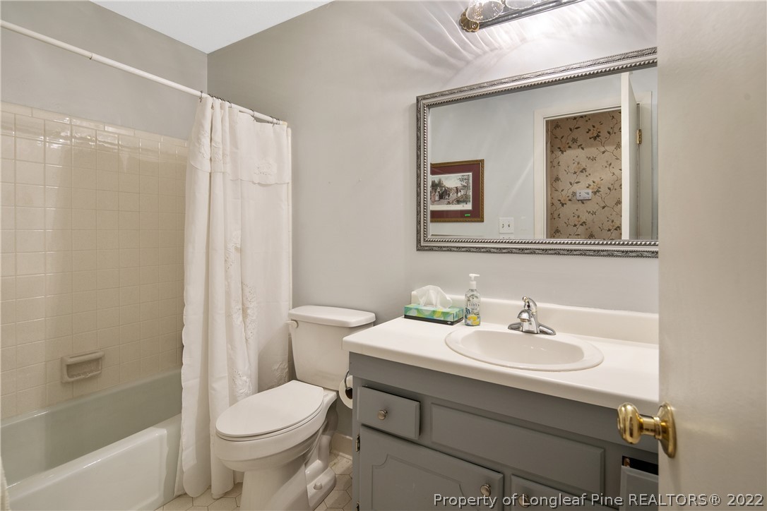 211 Duncan Road Spring Lake, NC 28390 - Photo 36 of 46 a bathroom with a sink mirror and a toilet