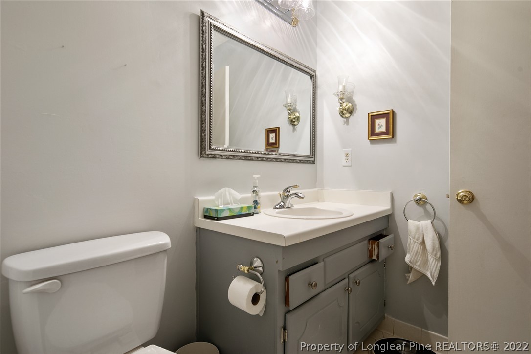 211 Duncan Road Spring Lake, NC 28390 - Photo 37 of 46 a bathroom with a sink a toilet and mirror