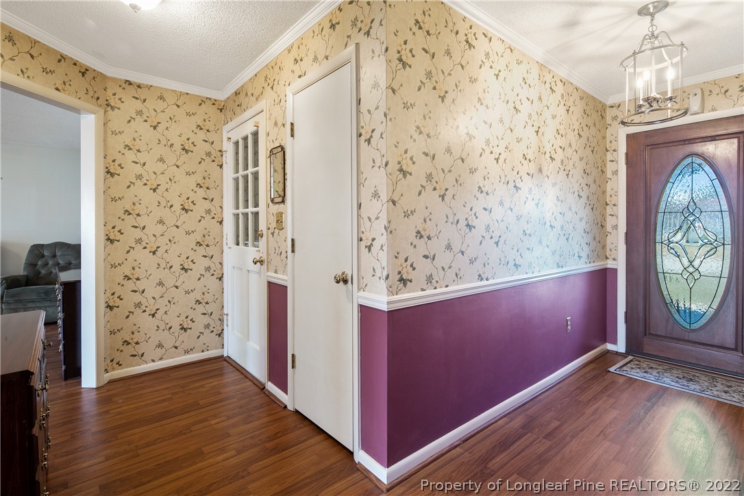 211 Duncan Road Spring Lake, NC 28390 - Photo 7 of 46 a view of a hallway with wooden floor and entryway