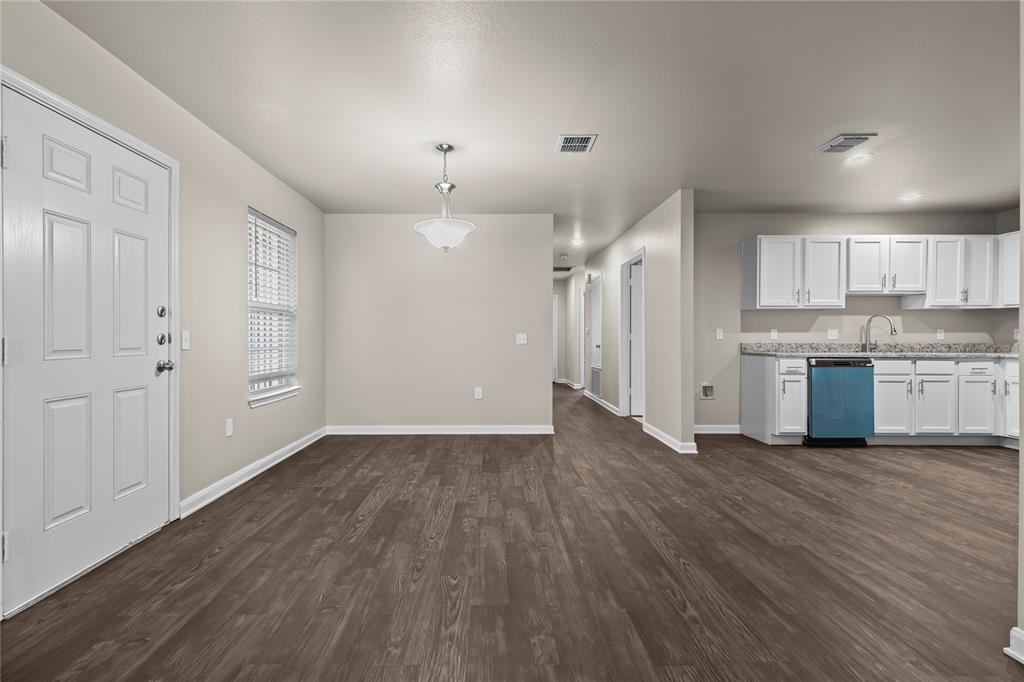 2723 Parsons Street Dallas, TX 75215 - Photo 8 of 28 a view of a kitchen with a fridge and wooden floor