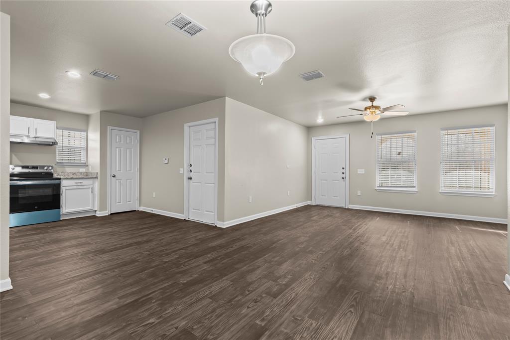 2723 Parsons Street Dallas, TX 75215 - Photo 9 of 28 a view of an empty room with a window and wooden floor