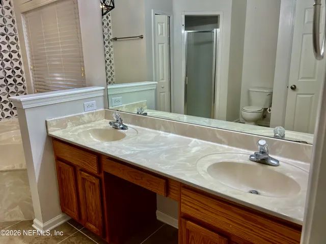 a bathroom with a sink double vanity and a mirror