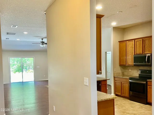 a kitchen with stainless steel appliances a large counter top and a stove
