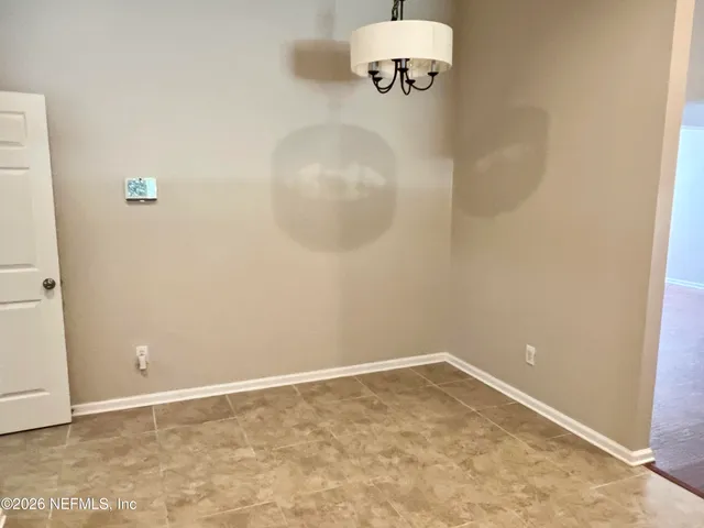 a view of a room with a hanging light