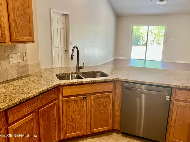 a kitchen with granite countertop a sink and a window