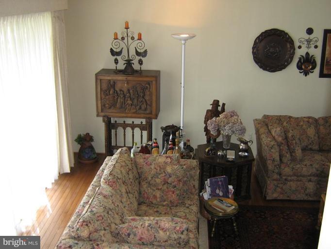 4003 Ferrara Drive Silver Spring, MD 20906 - Photo 14 of 29 a living room with furniture and a chandelier