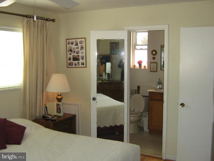 4003 Ferrara Drive Silver Spring, MD 20906 - Photo 16 of 29 a bedroom with a bed and a table in it