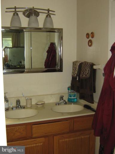 4003 Ferrara Drive Silver Spring, MD 20906 - Photo 17 of 29 a bathroom with a sink and mirror