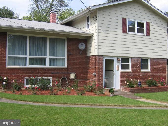 4003 Ferrara Drive Silver Spring, MD 20906 - Photo 3 of 29 a front view of a house with a garden