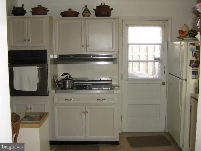 4003 Ferrara Drive Silver Spring, MD 20906 - Photo 24 of 29 a kitchen with stainless steel appliances granite countertop a refrigerator and a stove