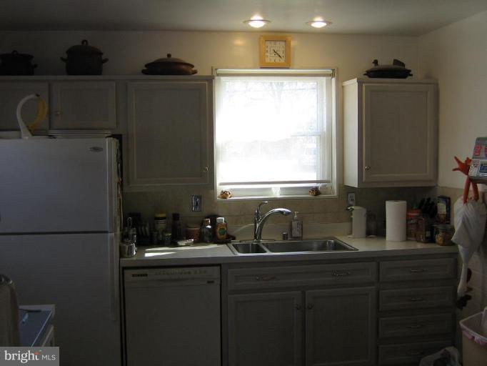 4003 Ferrara Drive Silver Spring, MD 20906 - Photo 25 of 29 a kitchen with a sink and a refrigerator