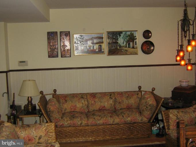 4003 Ferrara Drive Silver Spring, MD 20906 - Photo 26 of 29 a living room with furniture and painting on the wall