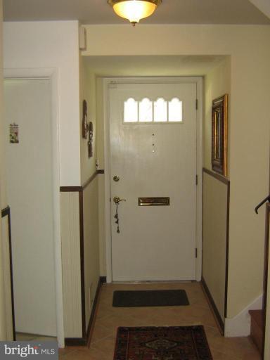 4003 Ferrara Drive Silver Spring, MD 20906 - Photo 27 of 29 a view of a hallway with wooden floor and a bathroom