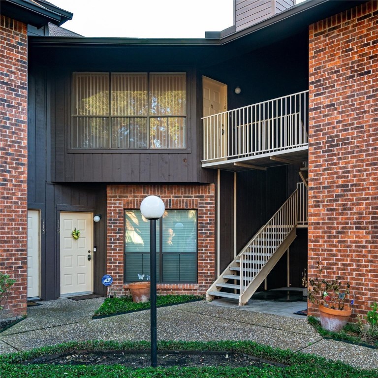 3100 Walnut Bend Lane, Unit 116 Houston, TX 77042 - Photo 1 of 15 a front view of a house with a yard