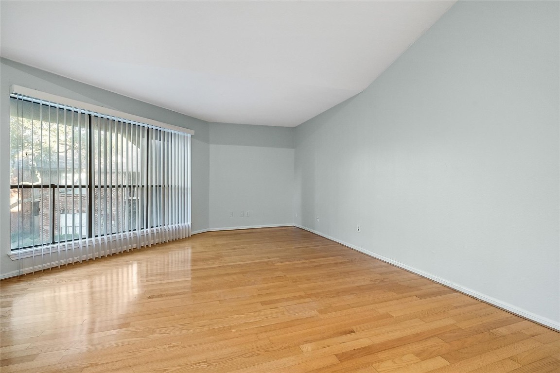 3100 Walnut Bend Lane, Unit 116 Houston, TX 77042 - Photo 4 of 15 a view of an empty room with wooden floor