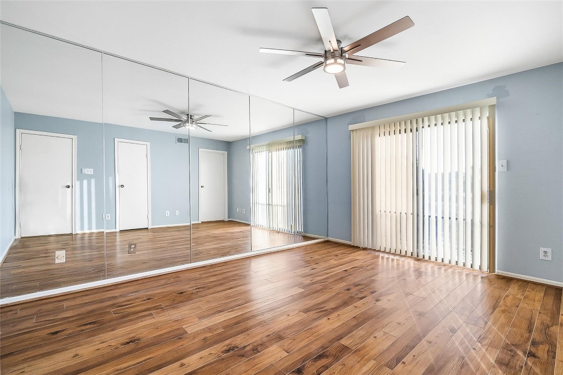 3100 Walnut Bend Lane, Unit 116 Houston, TX 77042 - Photo 9 of 15 a view of an empty room with wooden floor and a window