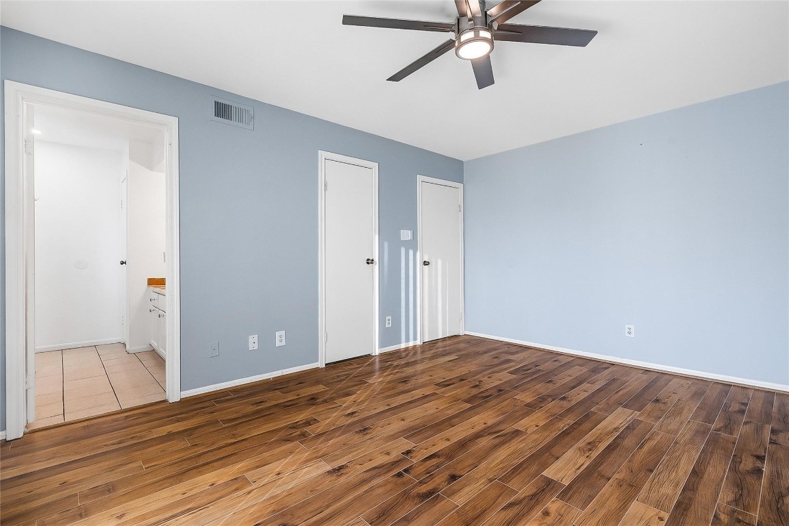 3100 Walnut Bend Lane, Unit 116 Houston, TX 77042 - Photo 10 of 15 a view of a livingroom with wooden floor and a ceiling fan