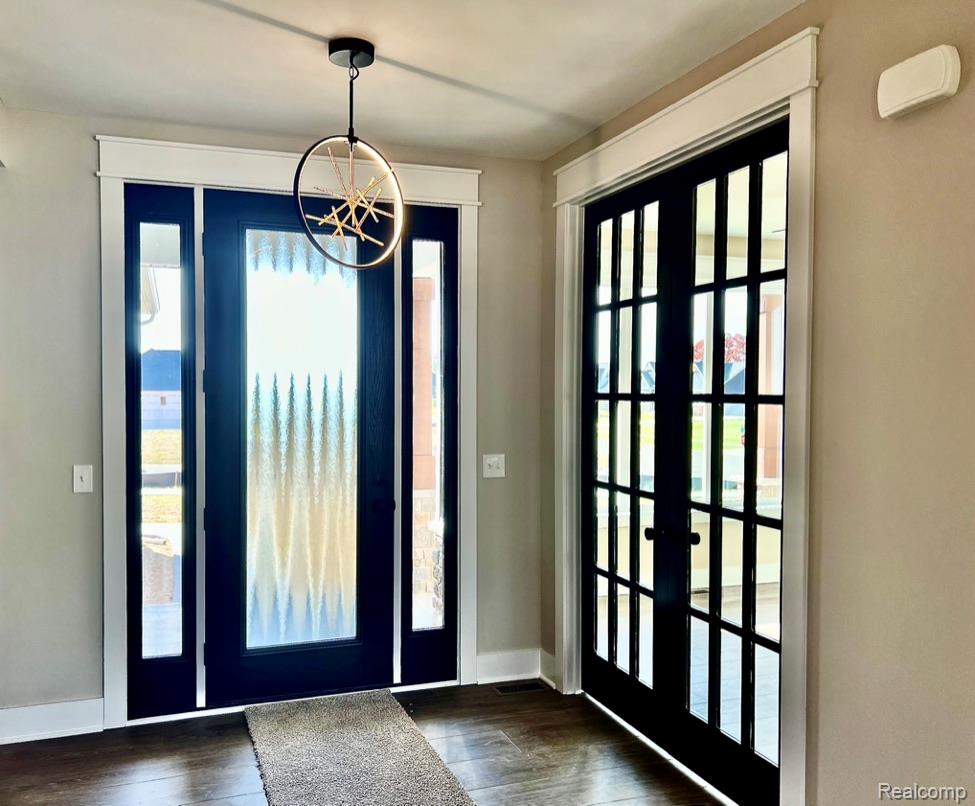 5382 Spring Meadows Way Linden, MI 48451 - Photo 5 of 20 Foyer entrance featuring dark wood-type flooring and french doors