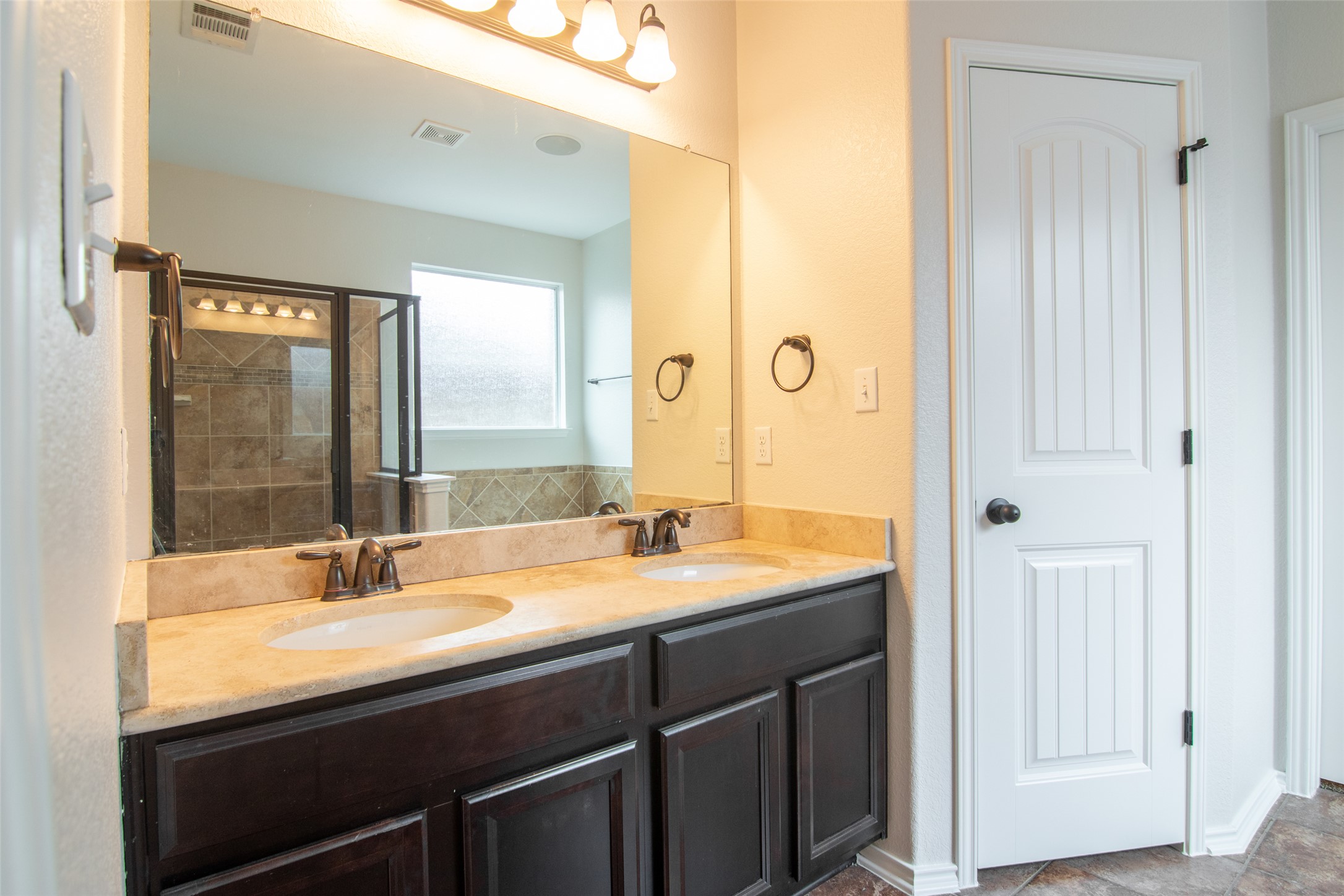 12104 Broten Street Austin, TX 78748 - Photo 18 of 32 Double vanity sinks and spacious shower create a highly functional bathroom.
