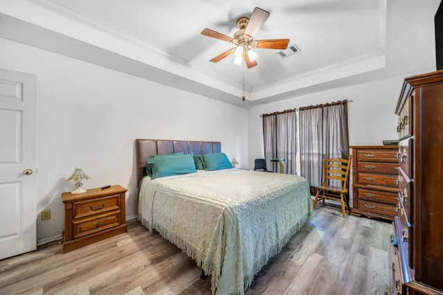 a bedroom with a bed and a chandelier