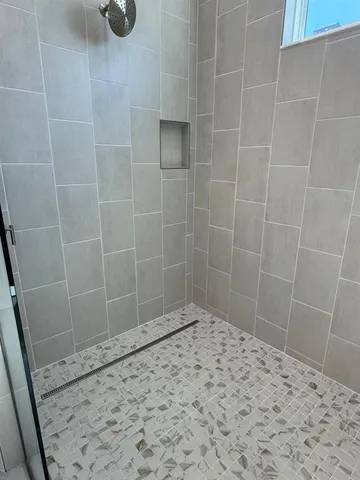 a view of kitchen with furniture and refrigerator