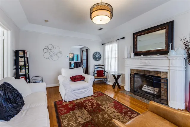 a living room with fireplace furniture and a flat screen tv