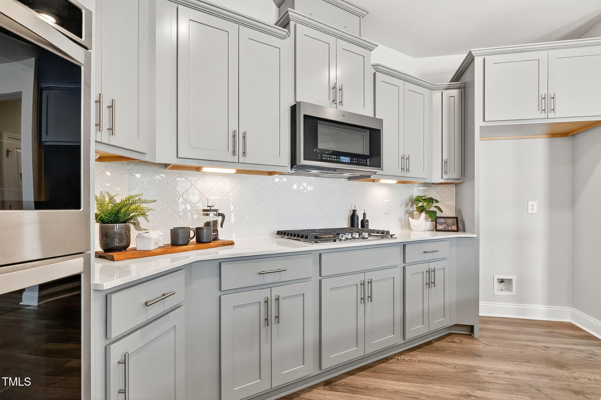1217 Linkwood Way Fuquay-Varina, NC 27526 - Photo 11 of 44 a kitchen with white cabinets and white appliances