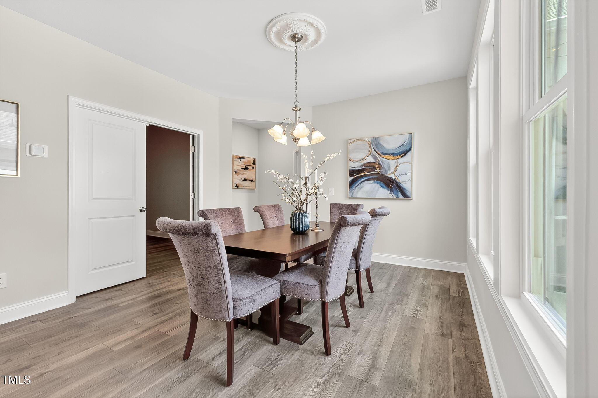 1217 Linkwood Way Fuquay-Varina, NC 27526 - Photo 13 of 44 a view of a dining room with furniture window and wooden floor