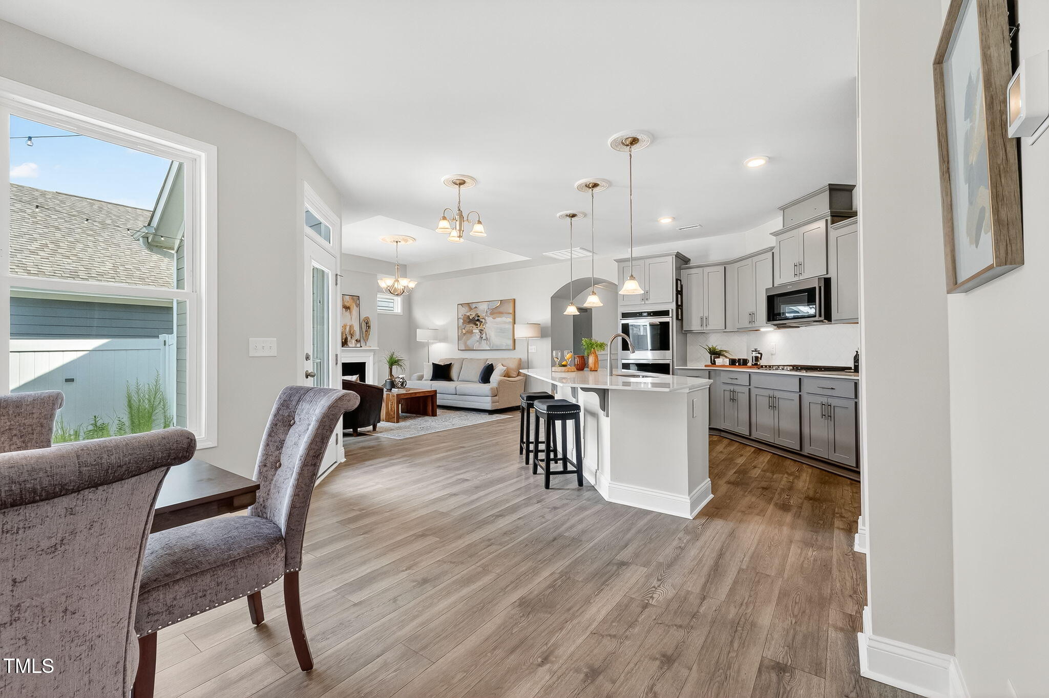 1217 Linkwood Way Fuquay-Varina, NC 27526 - Photo 16 of 44 a living room with lots of furniture and kitchen view