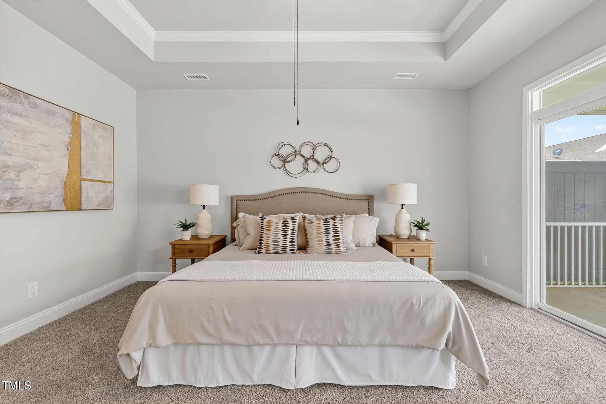 1217 Linkwood Way Fuquay-Varina, NC 27526 - Photo 20 of 44 a bedroom with a large bed and a chandelier