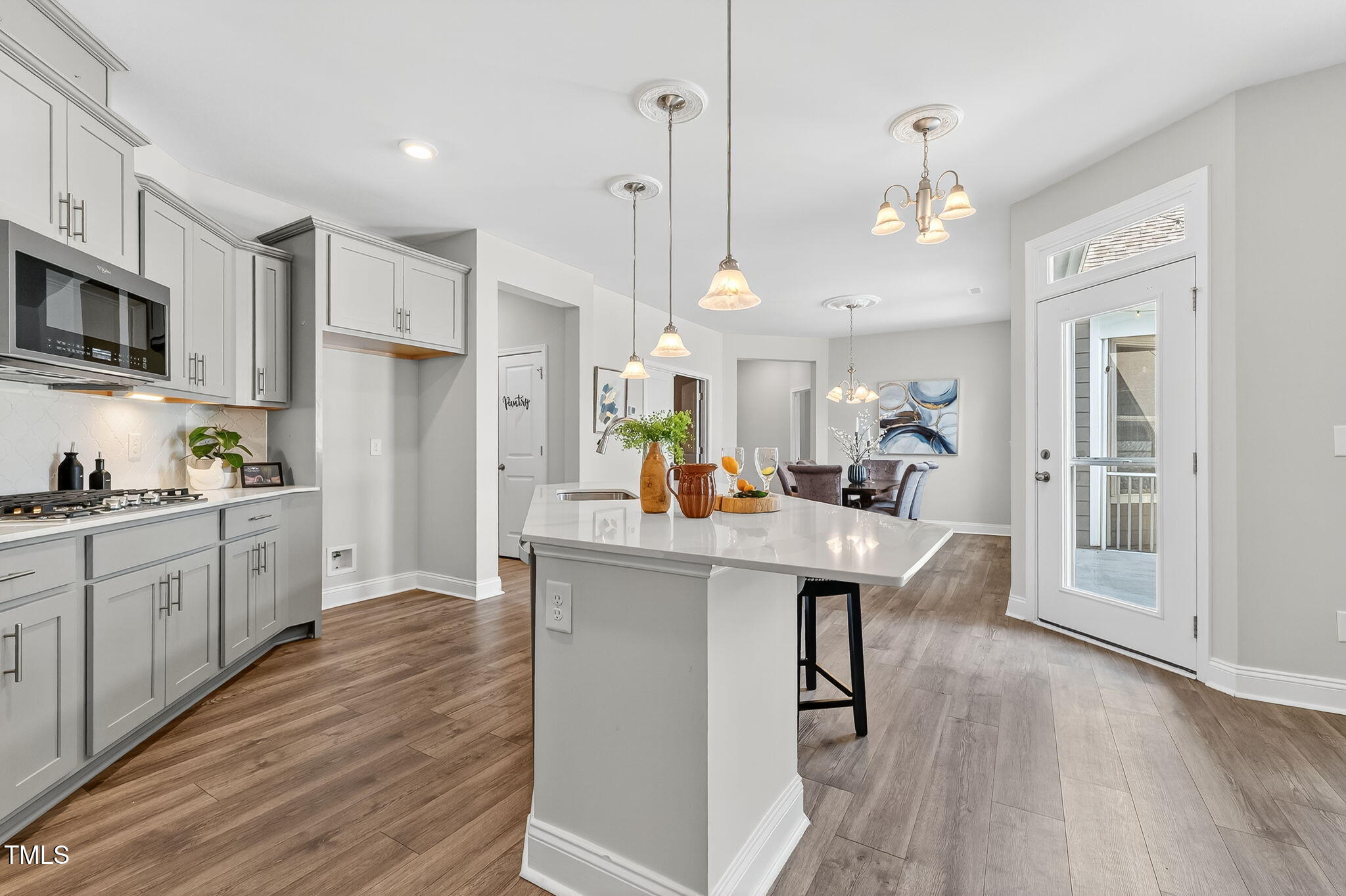 1217 Linkwood Way Fuquay-Varina, NC 27526 - Photo 2 of 44 a kitchen with stainless steel appliances kitchen island a refrigerator and a sink