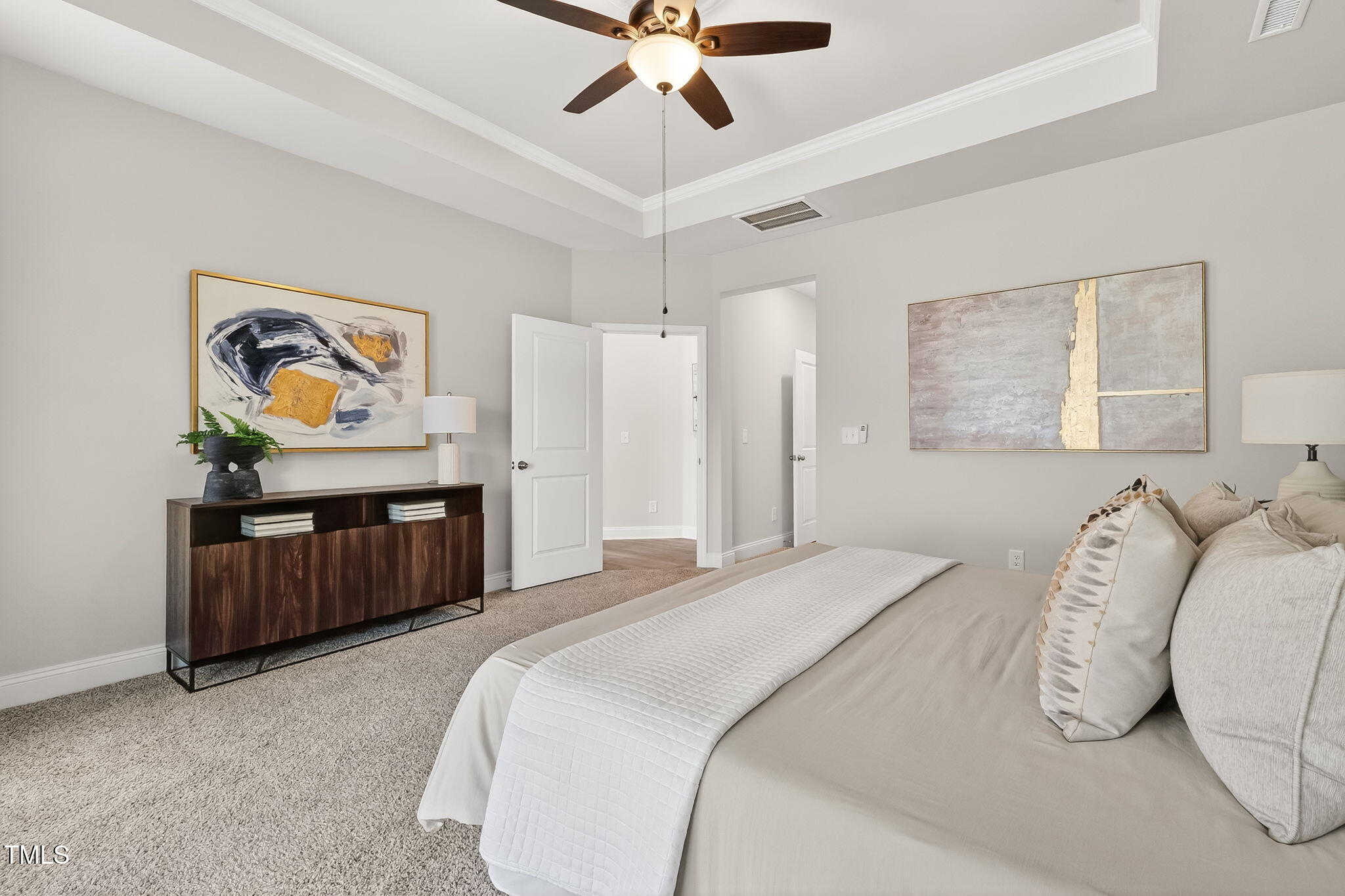 1217 Linkwood Way Fuquay-Varina, NC 27526 - Photo 22 of 44 a bedroom with a bed and a chandelier