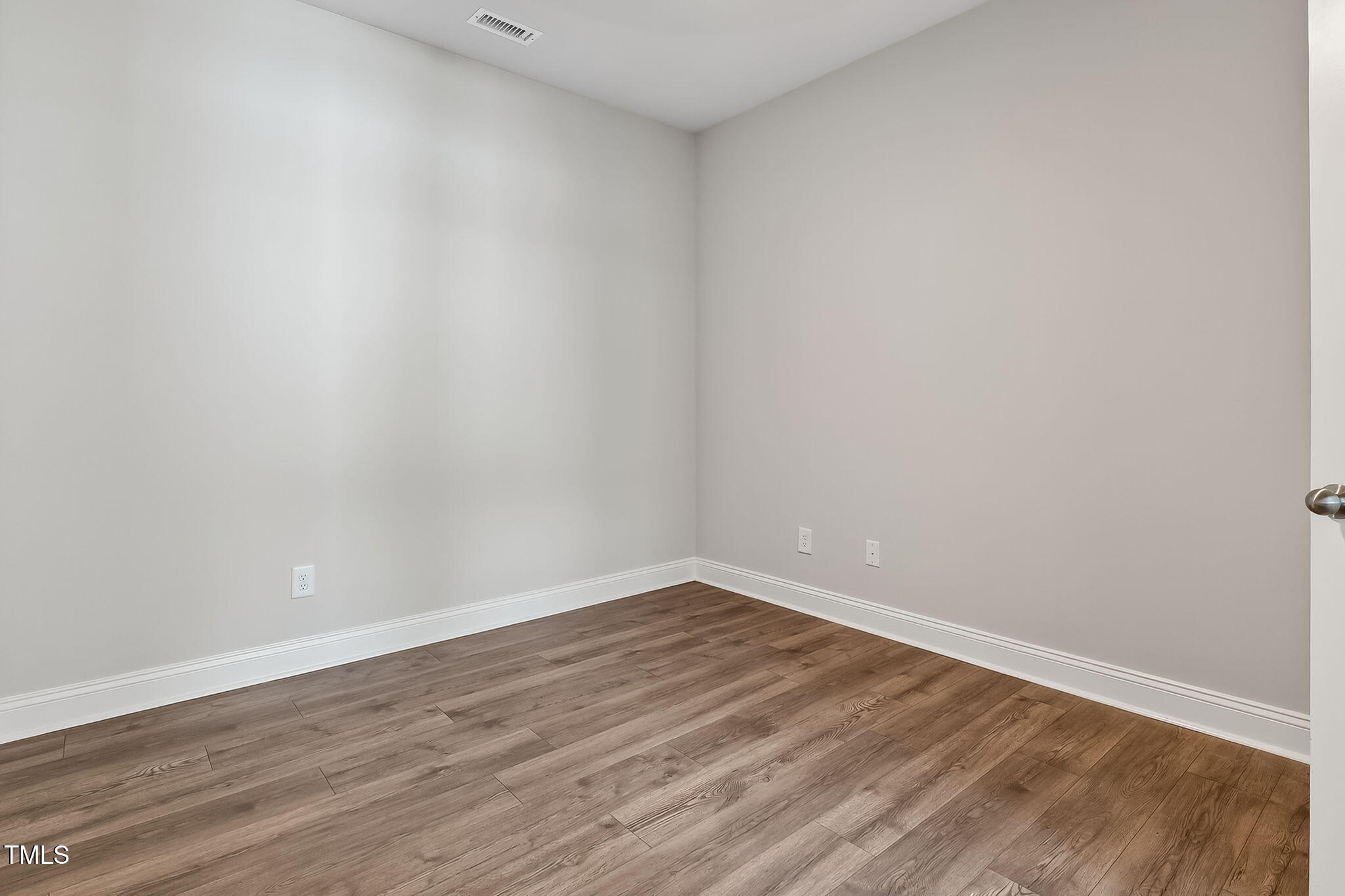1217 Linkwood Way Fuquay-Varina, NC 27526 - Photo 33 of 44 a view of an empty room with wooden floor