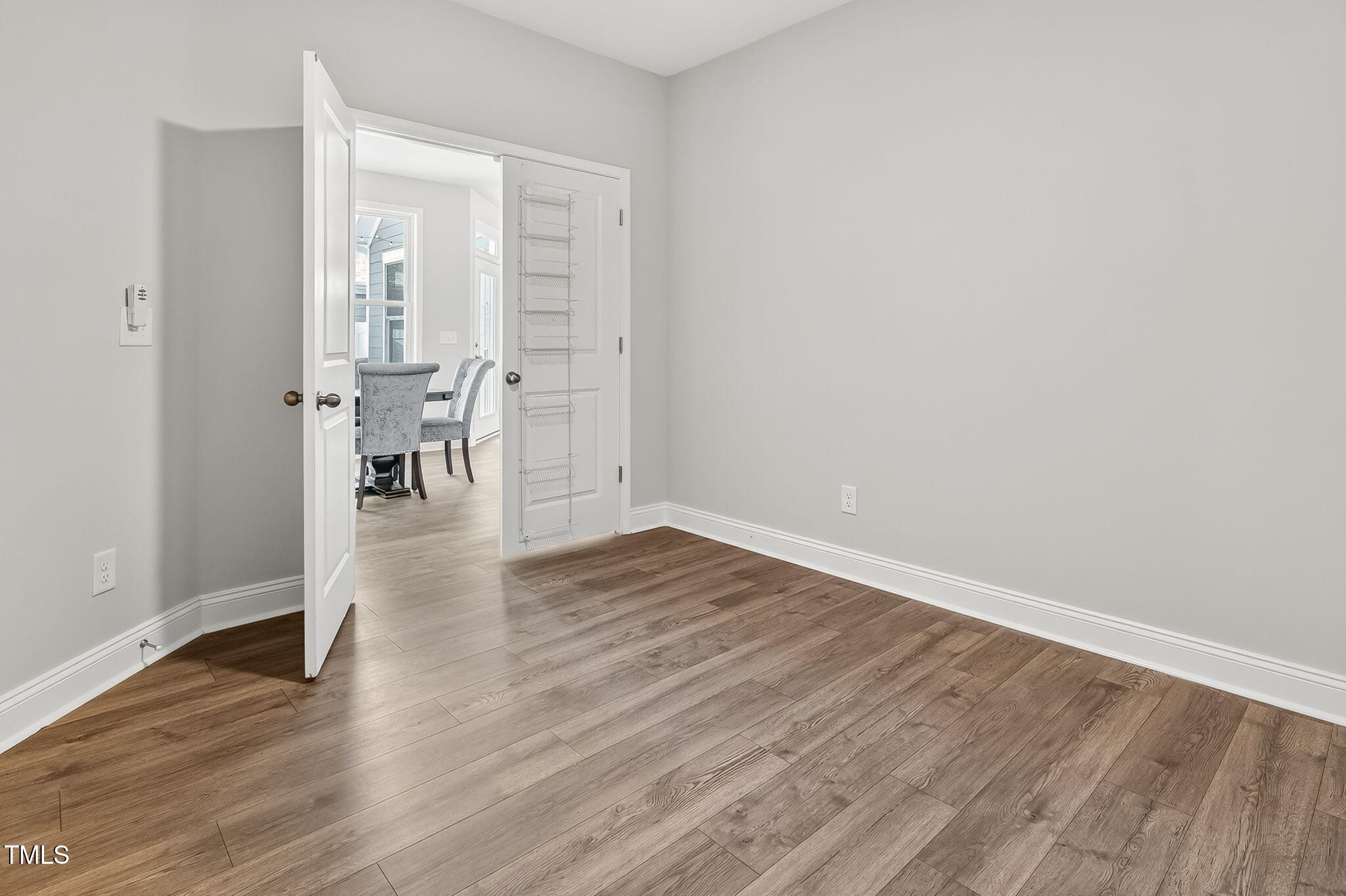 1217 Linkwood Way Fuquay-Varina, NC 27526 - Photo 34 of 44 a view of an empty room with wooden floor and a window