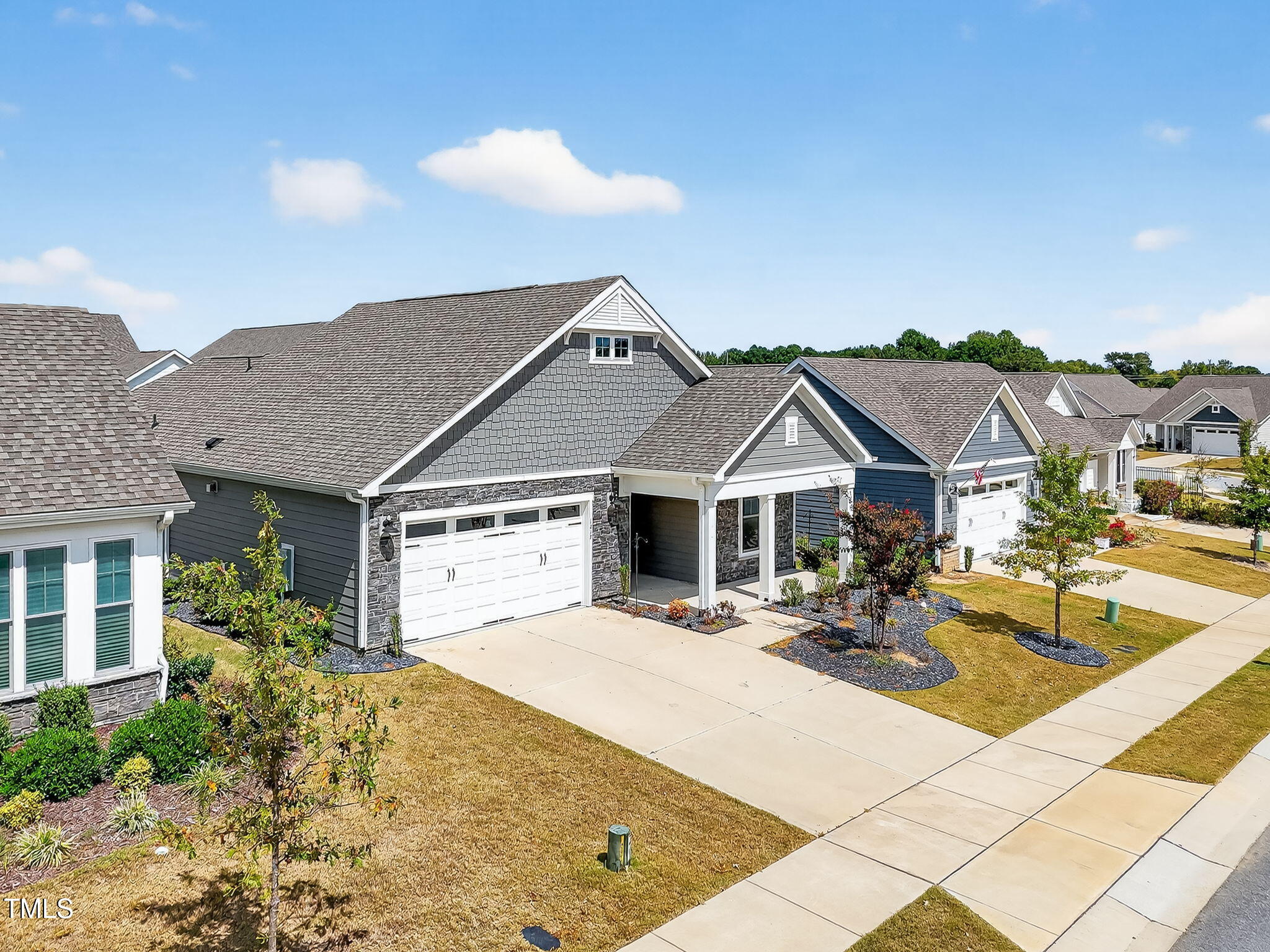 1217 Linkwood Way Fuquay-Varina, NC 27526 - Photo 42 of 44 a view of a white house with a large pool and couches chairs