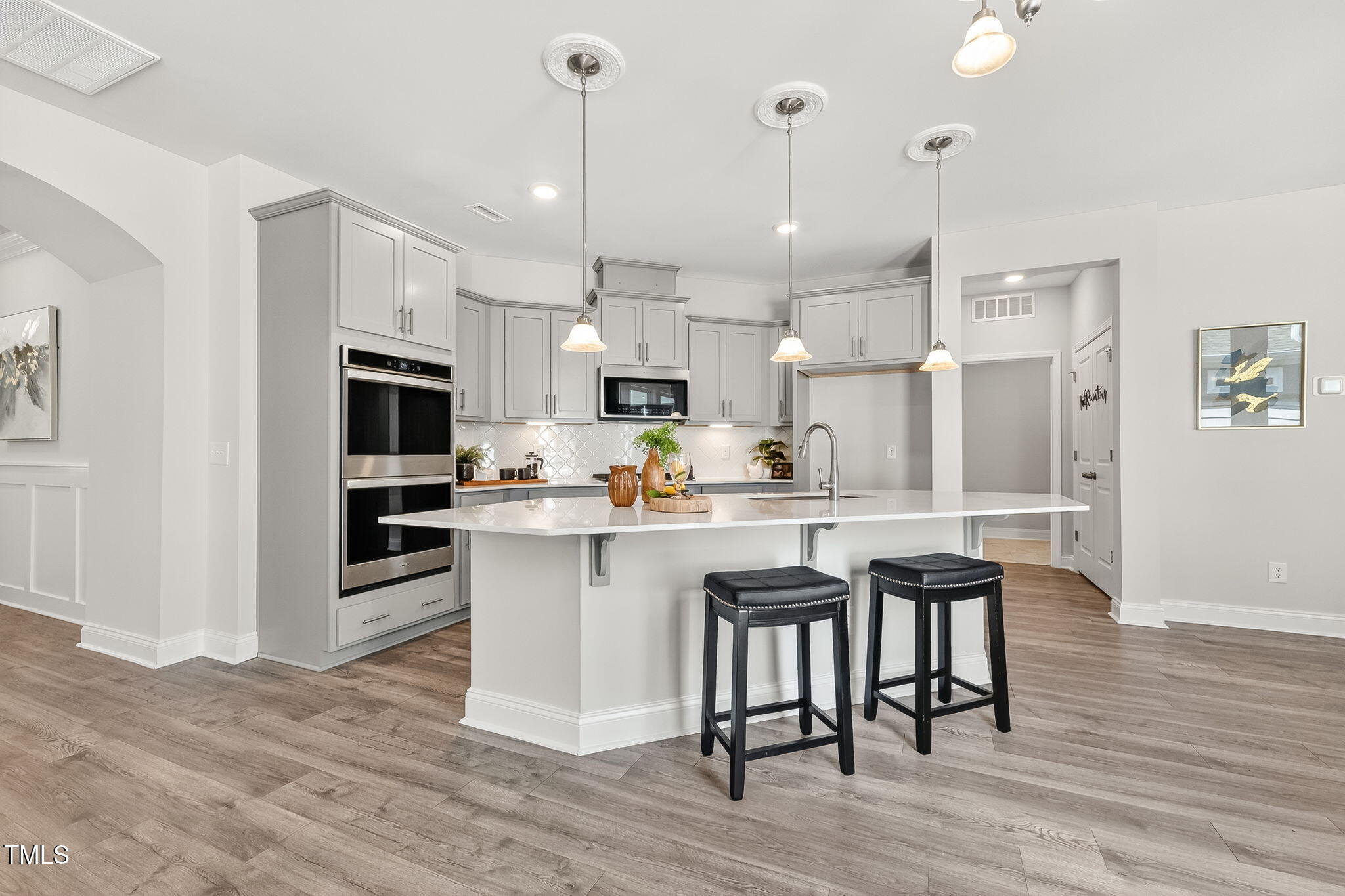 1217 Linkwood Way Fuquay-Varina, NC 27526 - Photo 8 of 44 a kitchen with cabinets and wooden floor