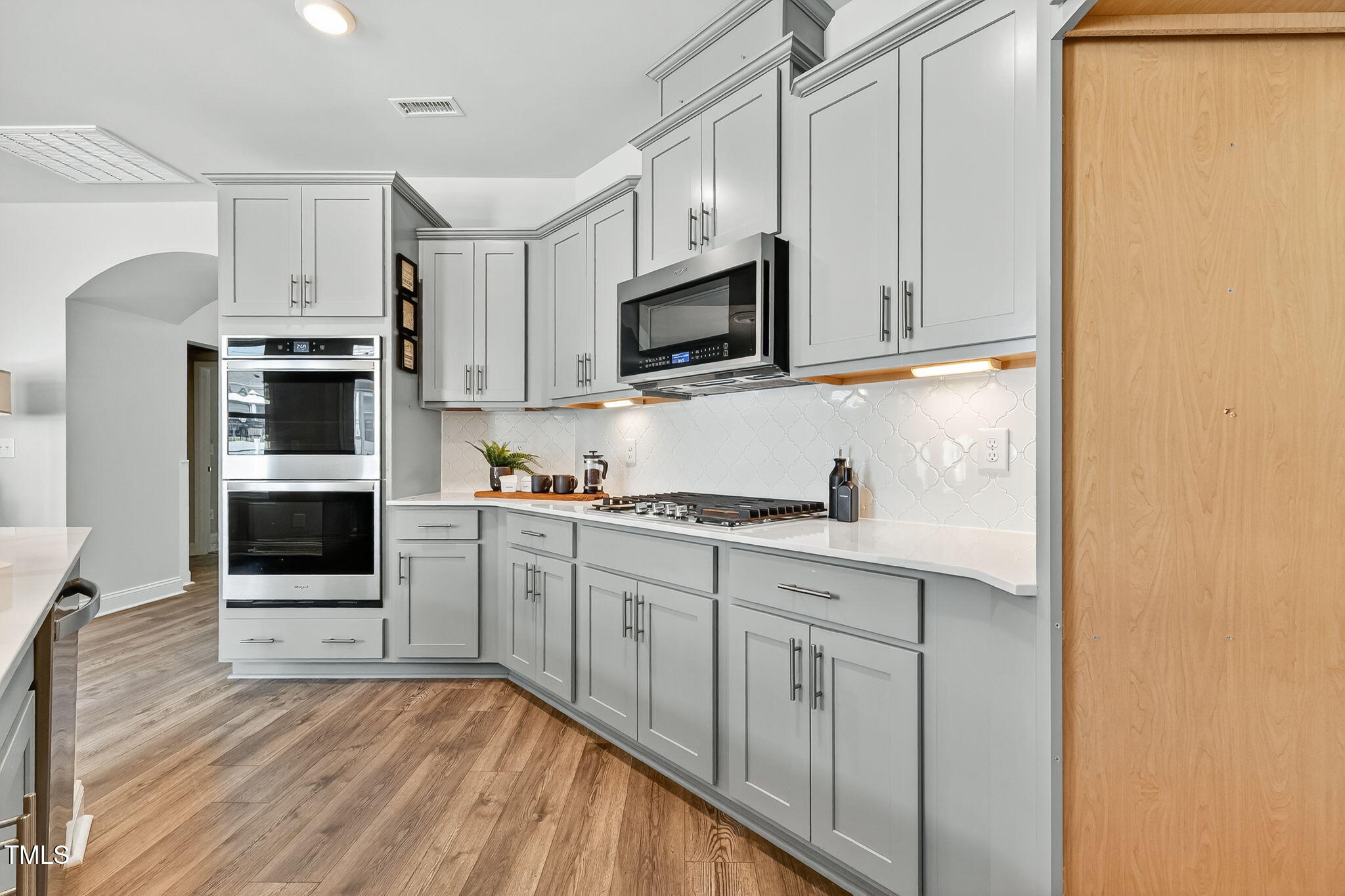 1217 Linkwood Way Fuquay-Varina, NC 27526 - Photo 10 of 44 a kitchen with stainless steel appliances granite countertop a stove a sink and a refrigerator