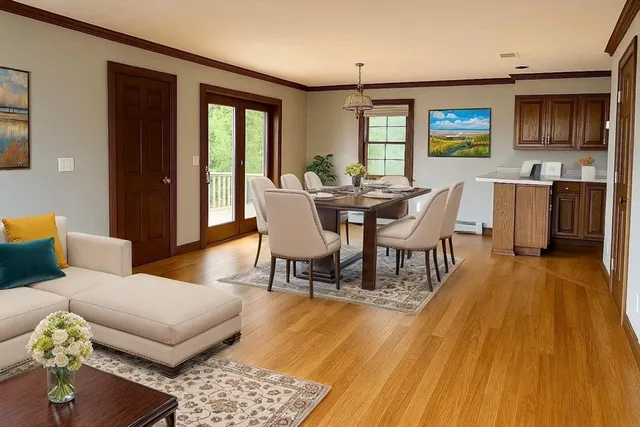 a view of a dining room with furniture and wooden floor