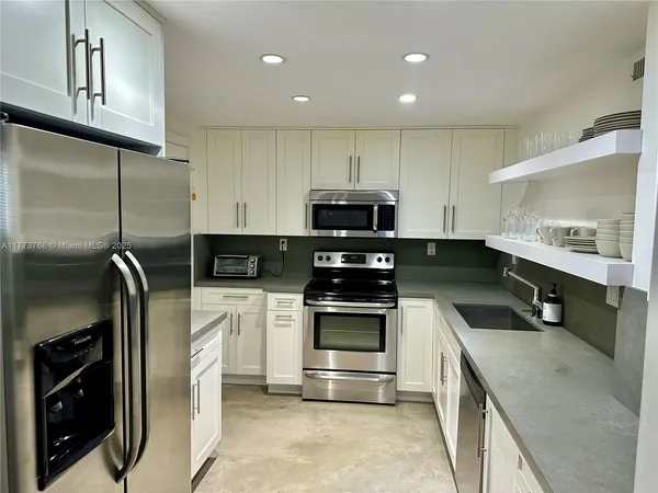 a kitchen with a sink stainless steel appliances and cabinets