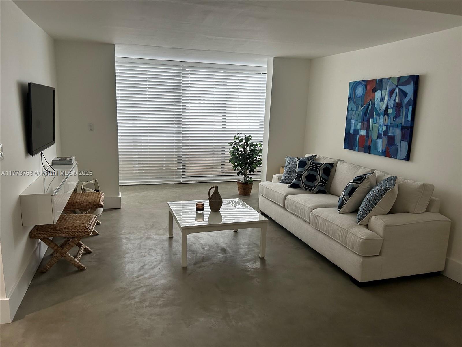 250 Galen Drive, Unit 25 Key Biscayne, FL 33149 - Photo 2 of 12 a living room with furniture and a flat screen tv