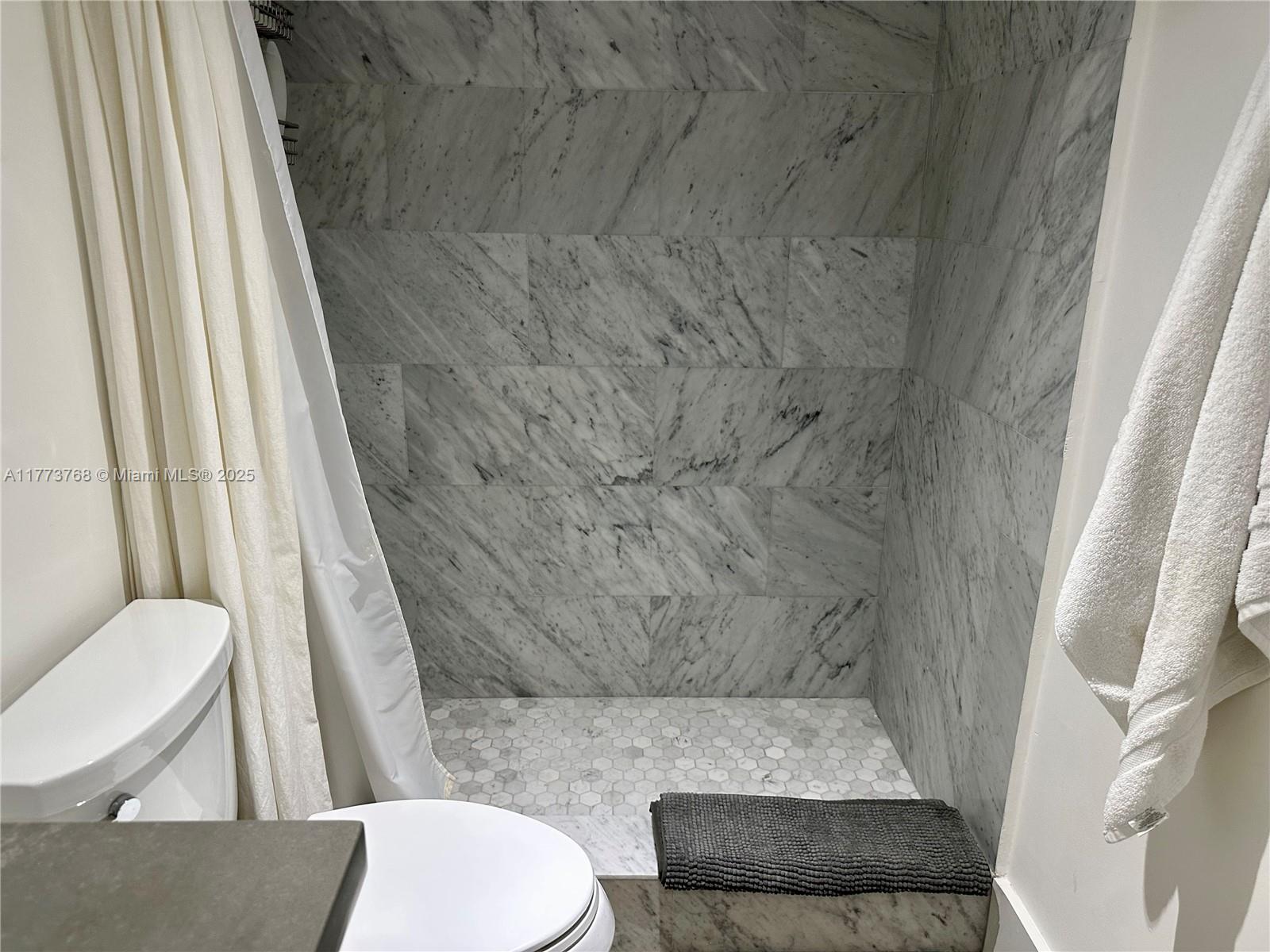 250 Galen Drive, Unit 25 Key Biscayne, FL 33149 - Photo 5 of 12 a bathroom with a toilet and a shower