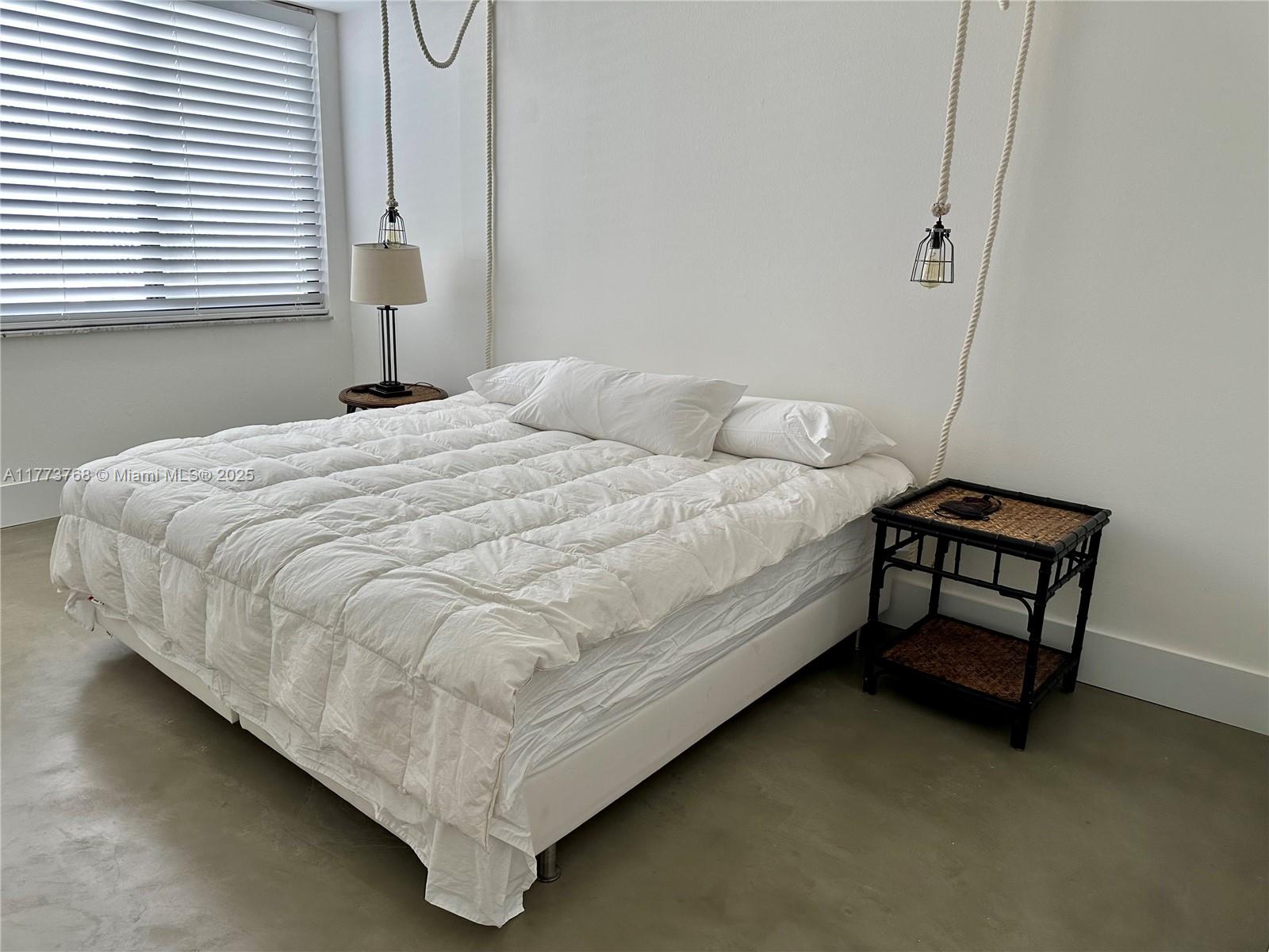 250 Galen Drive, Unit 25 Key Biscayne, FL 33149 - Photo 10 of 12 a bedroom with a bed and a window