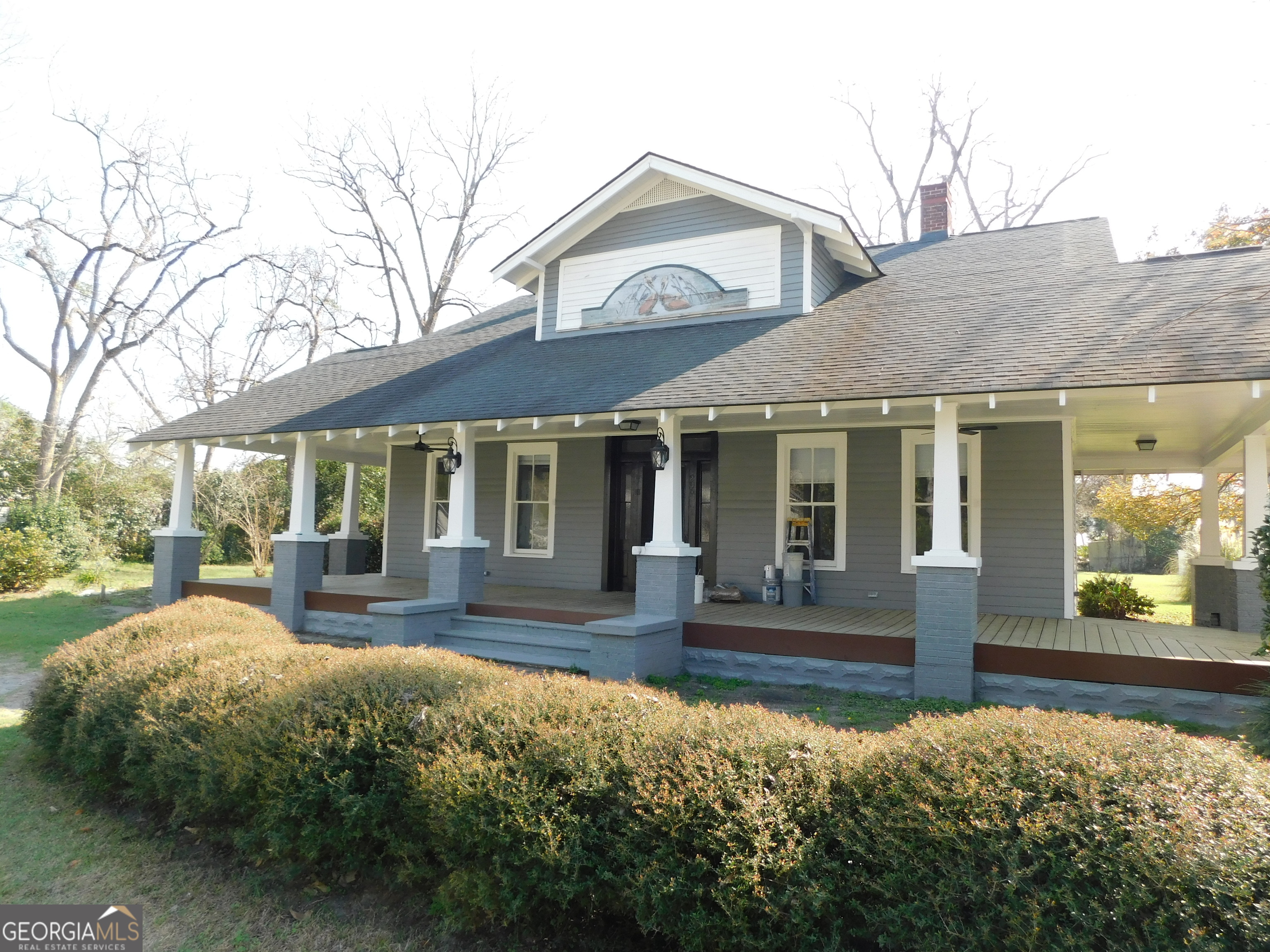 a front view of a house with garden and porch