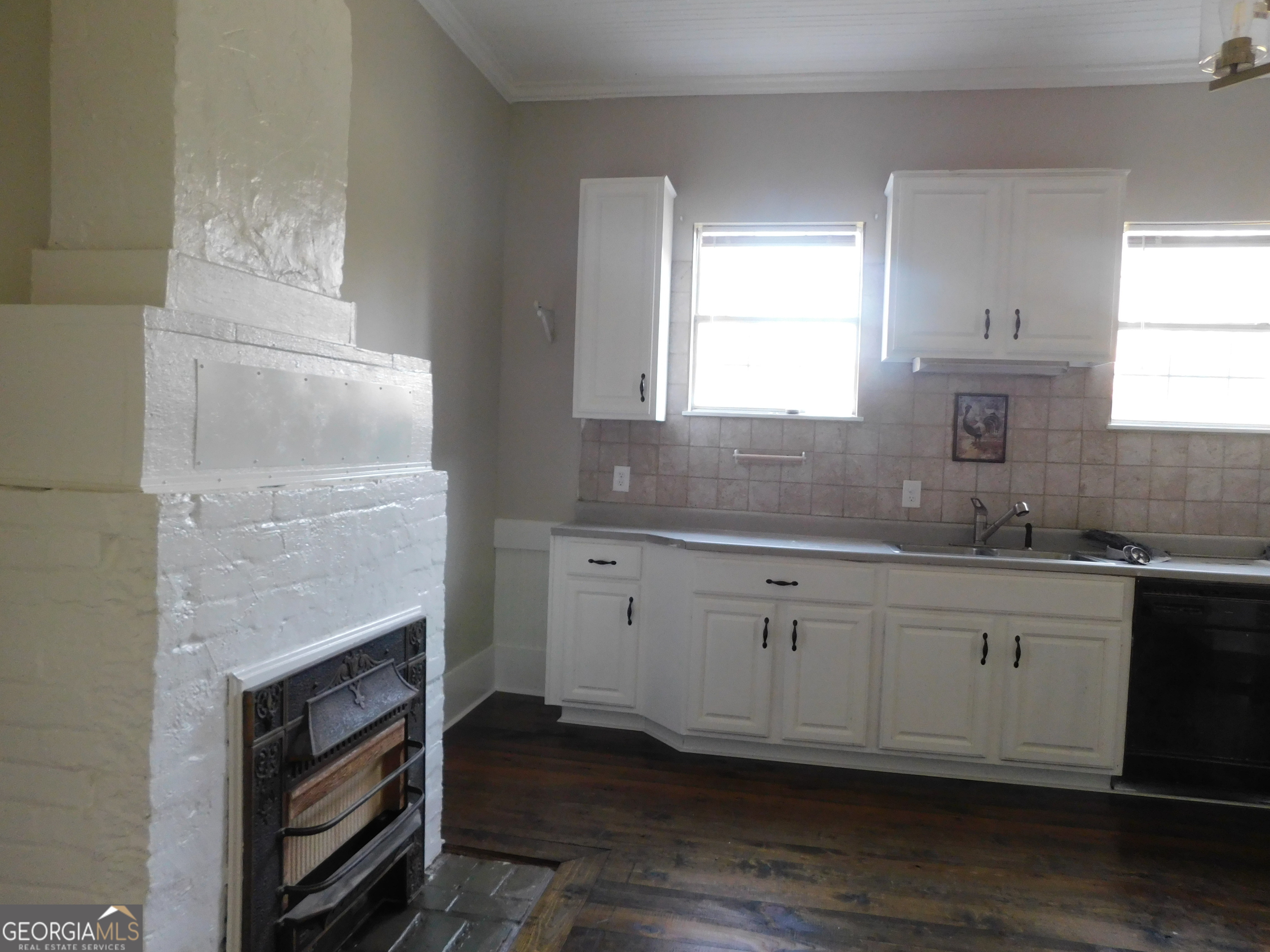 206 East Lane Street Brooklet, GA 30415 - Photo 15 of 33 a kitchen with granite countertop a fireplace a sink a window and cabinets