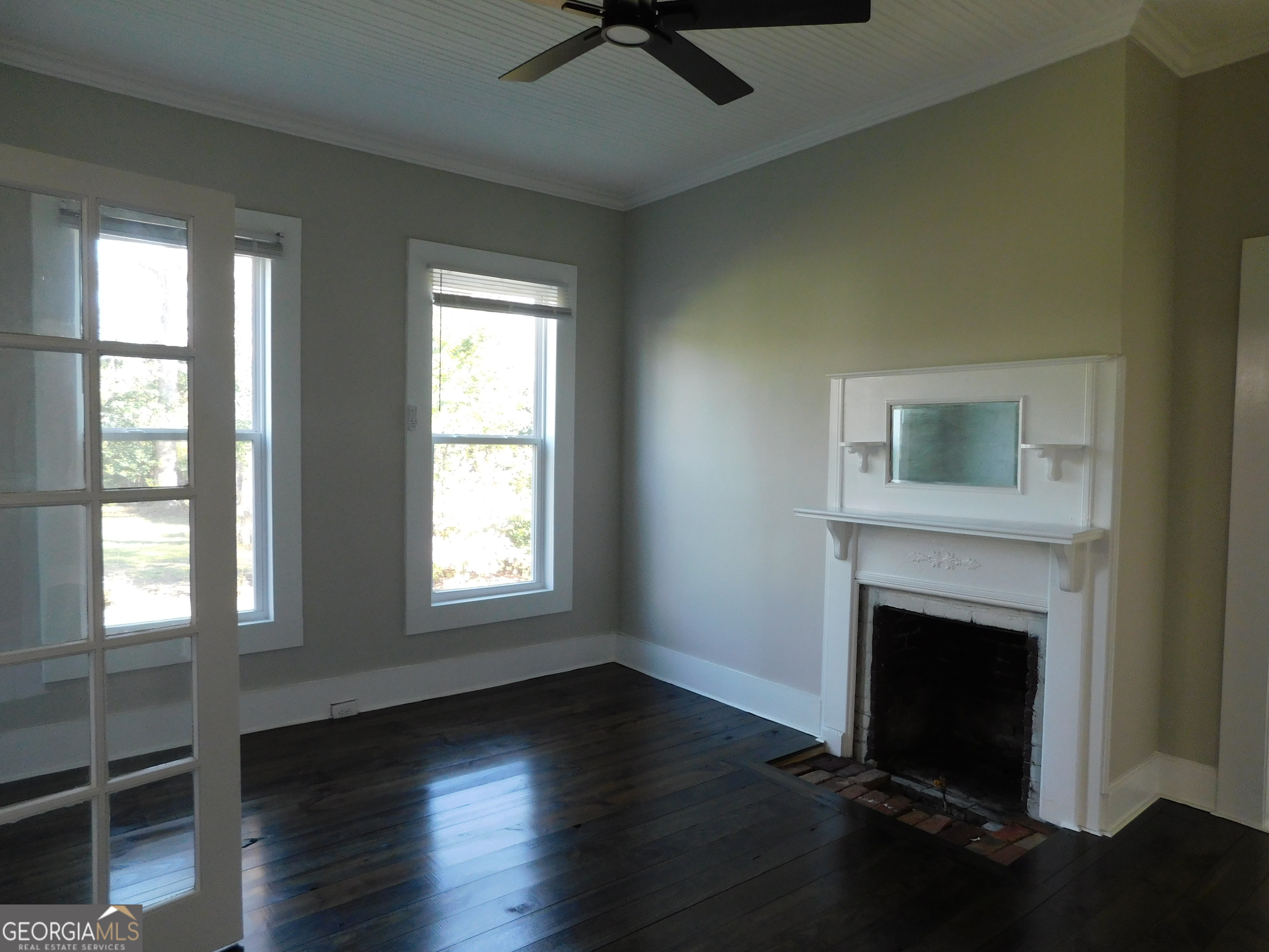 206 East Lane Street Brooklet, GA 30415 - Photo 18 of 33 wooden floor fireplace and windows in an empty room